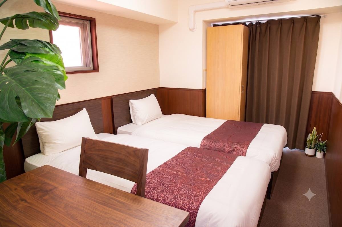 Two single beds with a red runner
