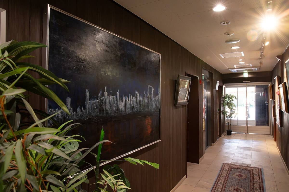 Corridor with a dark city painting and plants
